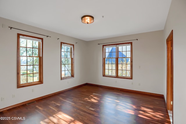 empty room featuring dark wood-type flooring