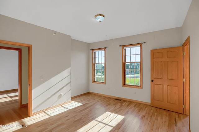 spare room featuring light wood-type flooring