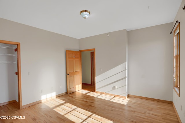 unfurnished bedroom featuring light wood-type flooring and a closet