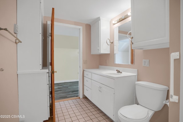 bathroom featuring tile patterned floors, vanity, and toilet