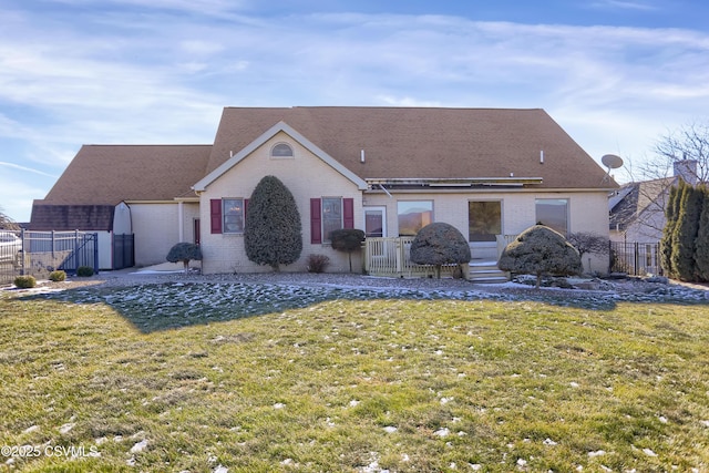 rear view of property with a lawn