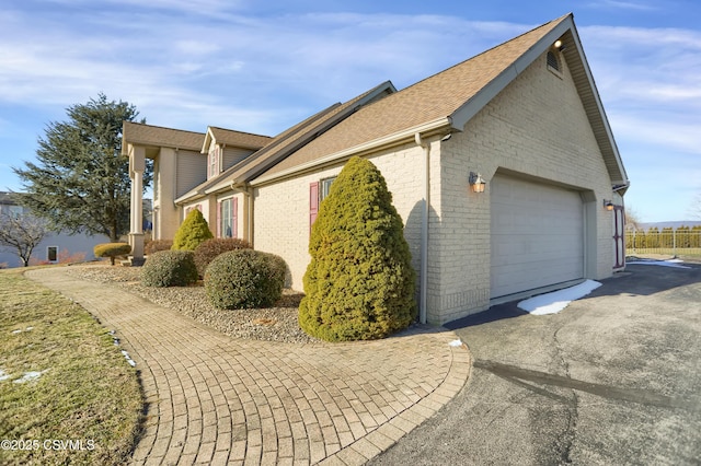 view of side of home featuring a garage