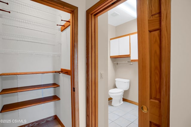 bathroom featuring toilet and tile patterned floors