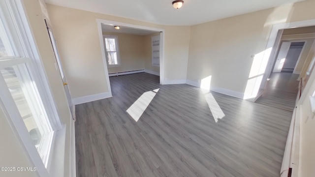 spare room featuring dark hardwood / wood-style floors and a baseboard radiator