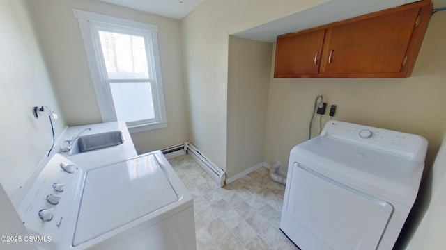 laundry room with sink, baseboard heating, independent washer and dryer, and cabinets