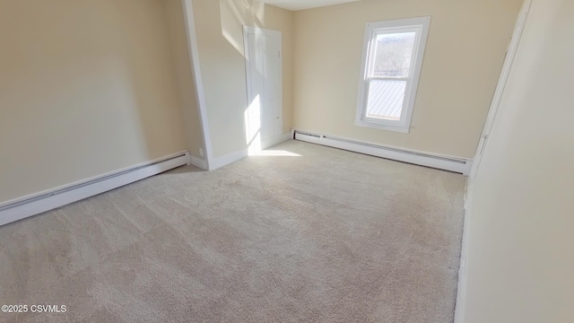 carpeted empty room featuring a baseboard heating unit