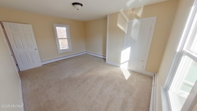 carpeted spare room featuring a baseboard radiator