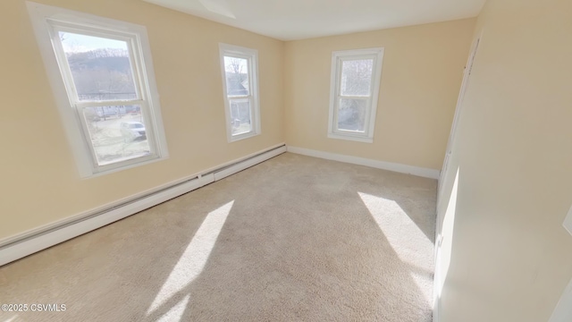 carpeted spare room with a baseboard radiator