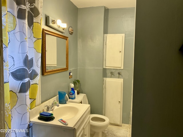 bathroom with toilet and vanity