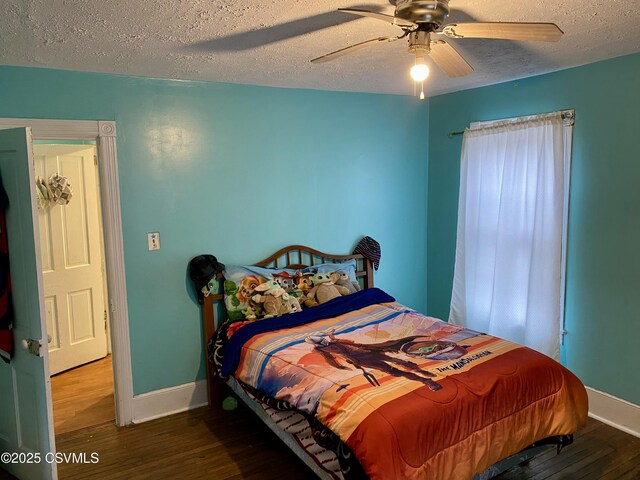 bedroom with a textured ceiling, ceiling fan, and hardwood / wood-style floors