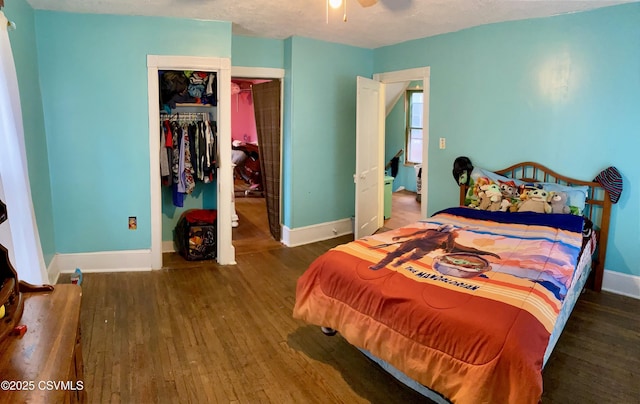 bedroom featuring a textured ceiling, ceiling fan, a closet, and dark hardwood / wood-style flooring