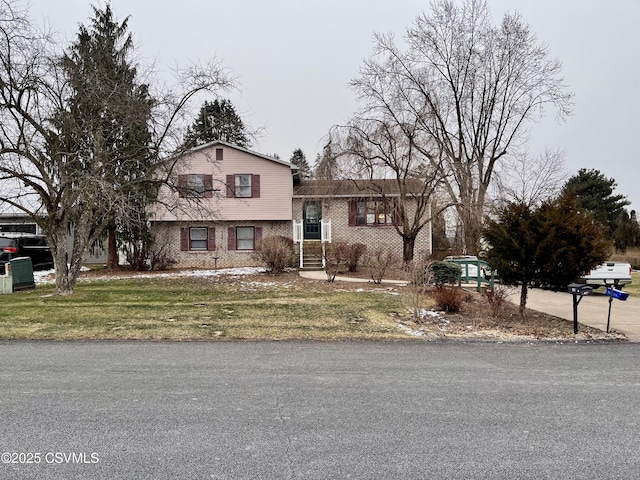 tri-level home with a front yard