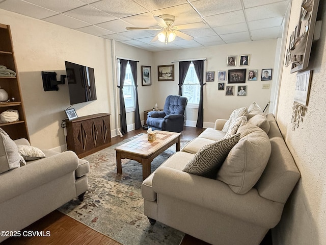 living room featuring a paneled ceiling, hardwood / wood-style flooring, and ceiling fan