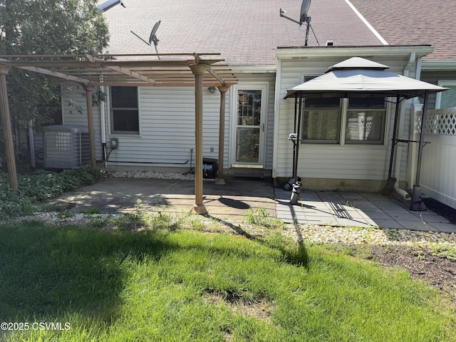 back of house with a gazebo, a pergola, central air condition unit, and a patio