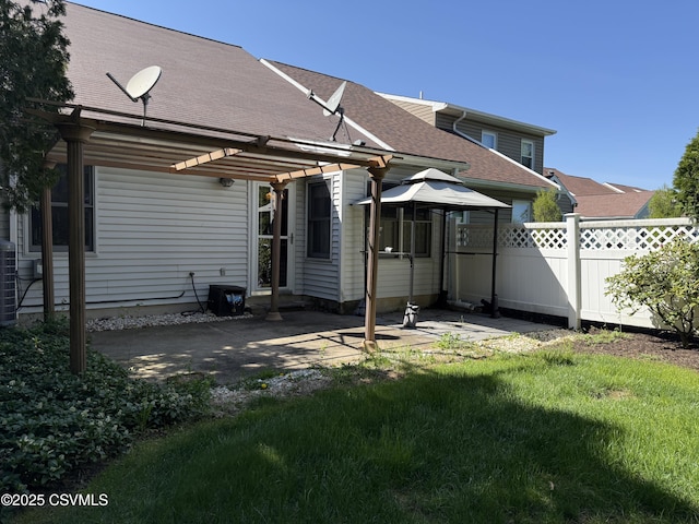 back of property with a patio, a gazebo, roof with shingles, a pergola, and fence