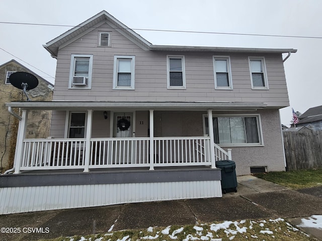 view of front of property featuring covered porch and cooling unit