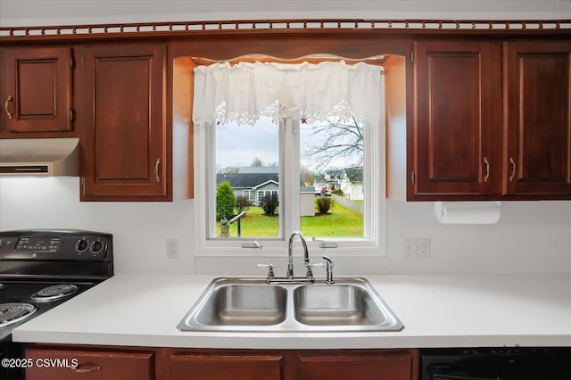 kitchen with sink, black appliances, and exhaust hood