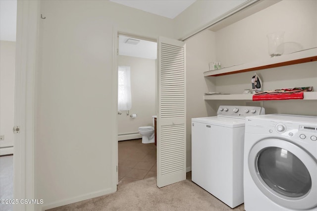 laundry area with a baseboard radiator, light colored carpet, and washer and clothes dryer