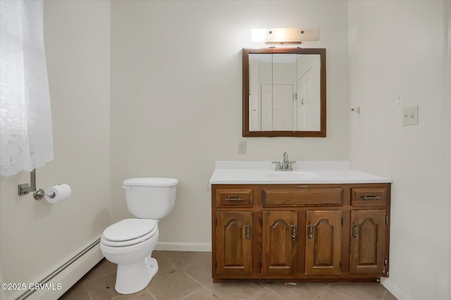 bathroom with vanity, toilet, a baseboard heating unit, and tile patterned floors