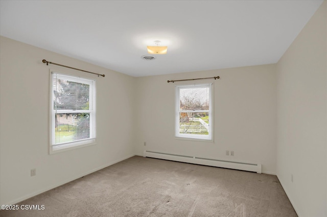 carpeted empty room featuring a baseboard radiator