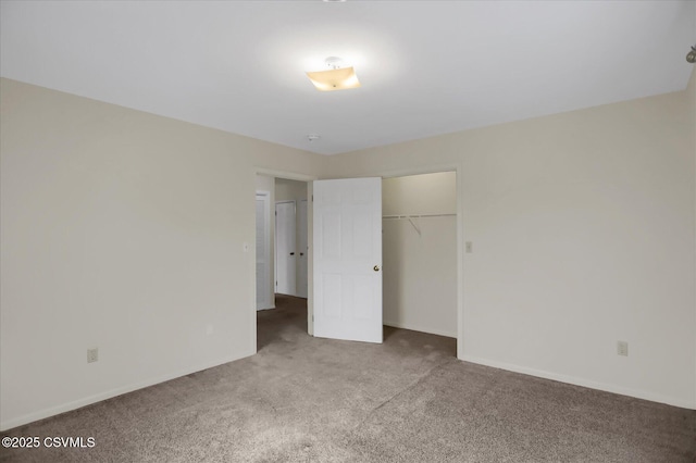 unfurnished bedroom with carpet flooring and a closet