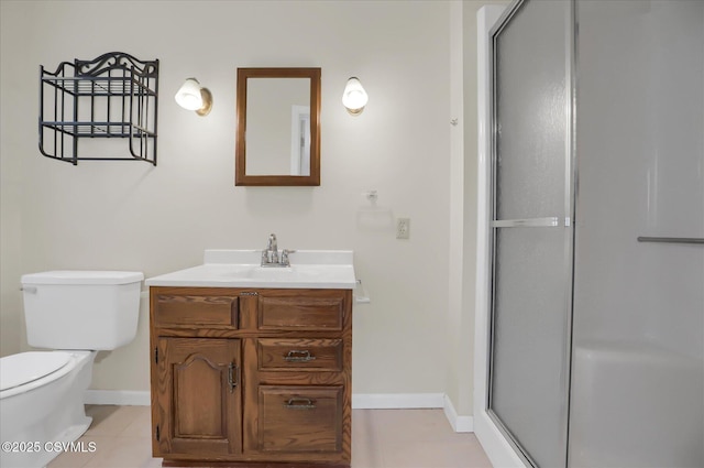 bathroom featuring vanity, toilet, tile patterned floors, and an enclosed shower