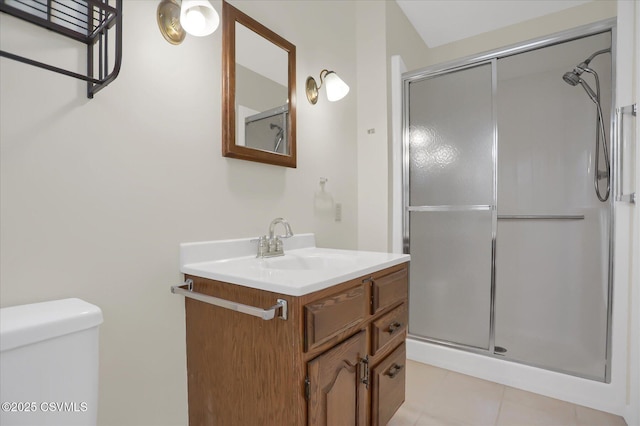 bathroom with walk in shower, vanity, toilet, and tile patterned flooring