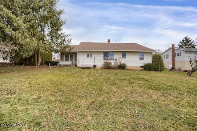 back of house with a sunroom and a yard