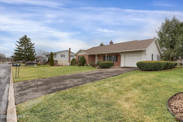 ranch-style home with a garage and a front lawn