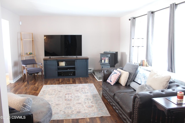 living room featuring a baseboard heating unit, dark hardwood / wood-style flooring, and a wood stove