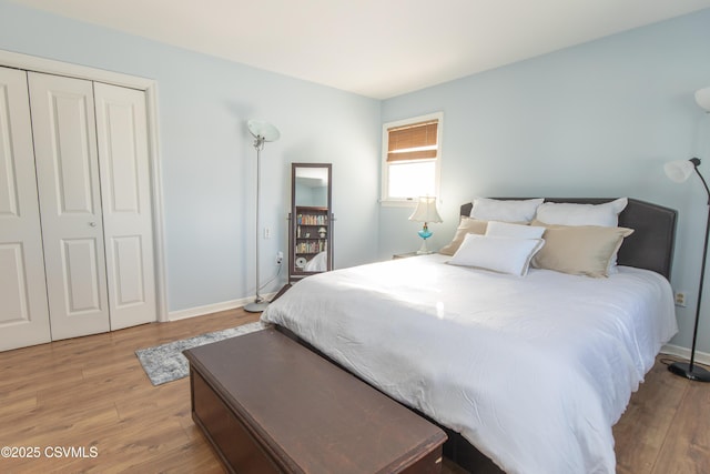 bedroom featuring light wood-type flooring and a closet