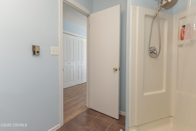 bathroom with tile patterned flooring and a shower