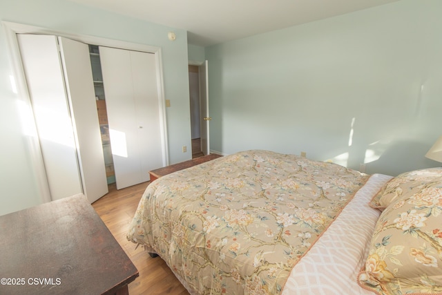 bedroom with light wood-type flooring and a closet