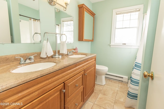 bathroom with toilet, vanity, tile patterned floors, and a baseboard radiator