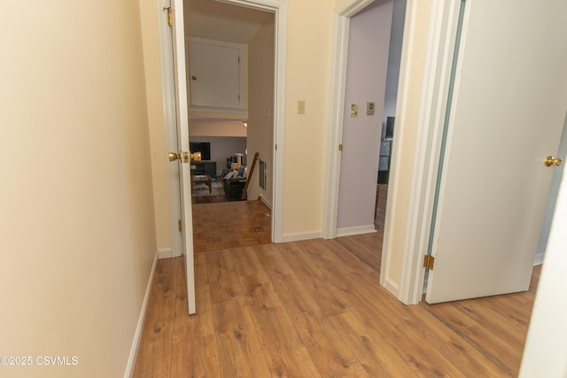 corridor with light hardwood / wood-style floors