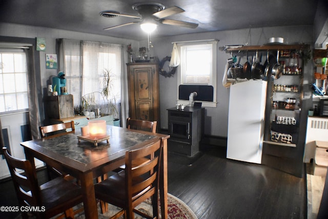 dining area featuring ceiling fan and dark hardwood / wood-style flooring