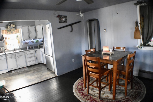 dining room with ceiling fan, dark hardwood / wood-style flooring, and sink