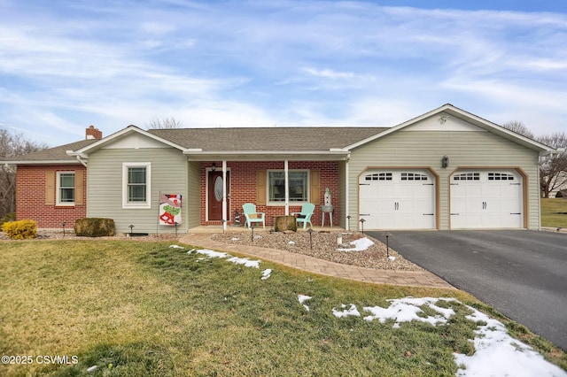 ranch-style house featuring a front yard and a garage