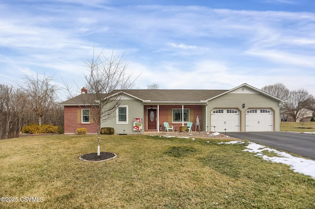 single story home featuring a front yard, covered porch, and a garage