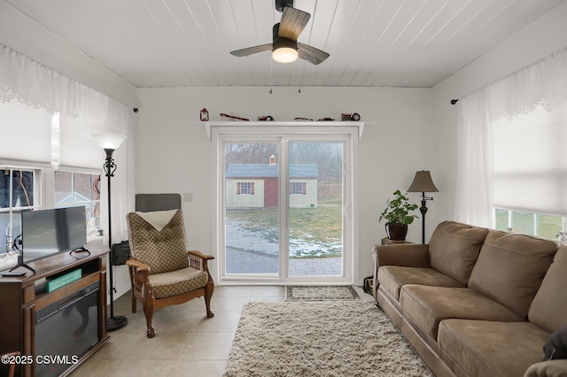 tiled living room with ceiling fan