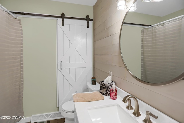 bathroom with toilet, a shower with shower curtain, wooden walls, and vanity