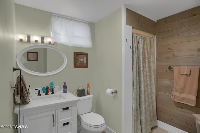 bathroom featuring toilet, vanity, wood walls, and a shower with shower curtain