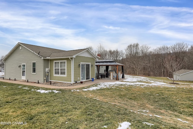 view of home's exterior featuring a gazebo, a storage unit, and a lawn