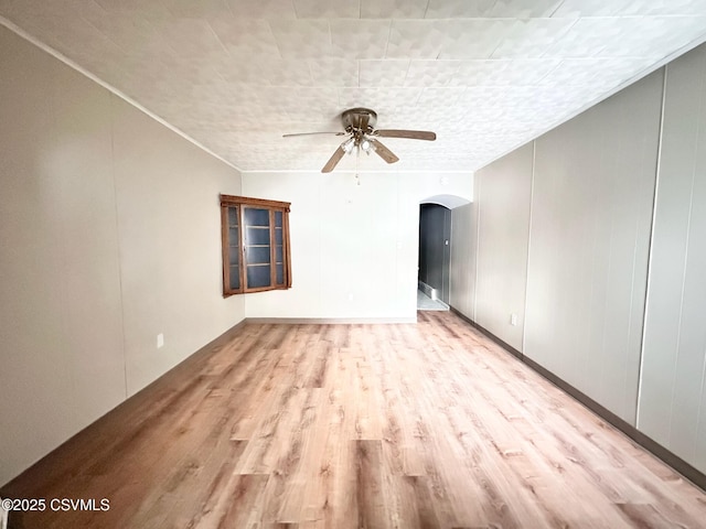 empty room featuring ceiling fan and light wood-type flooring