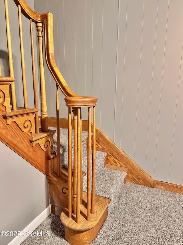 staircase featuring carpet