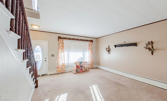 carpeted foyer entrance with crown molding and a baseboard radiator