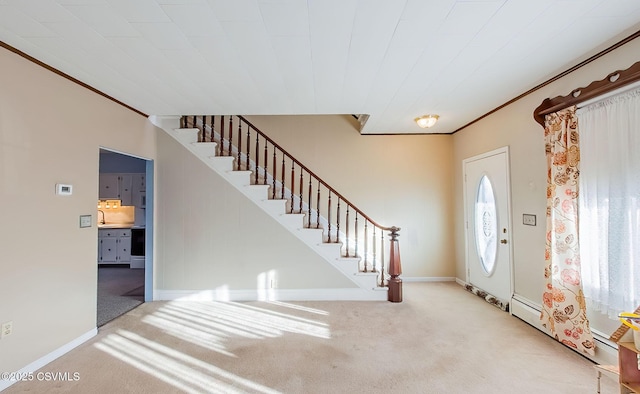 foyer featuring ornamental molding and light colored carpet