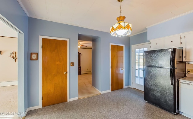 kitchen with white cabinetry, black fridge, light carpet, hanging light fixtures, and white dishwasher