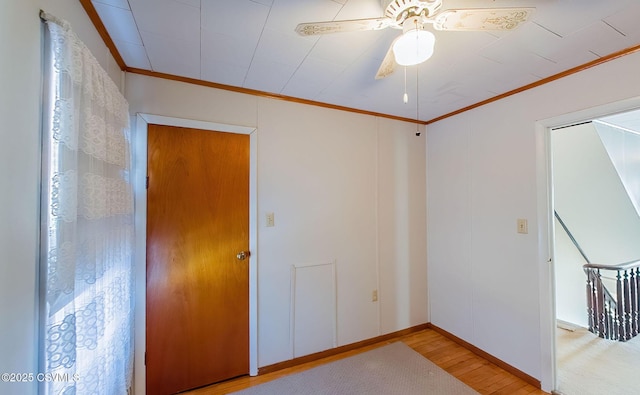 unfurnished room featuring ceiling fan, ornamental molding, and light hardwood / wood-style flooring