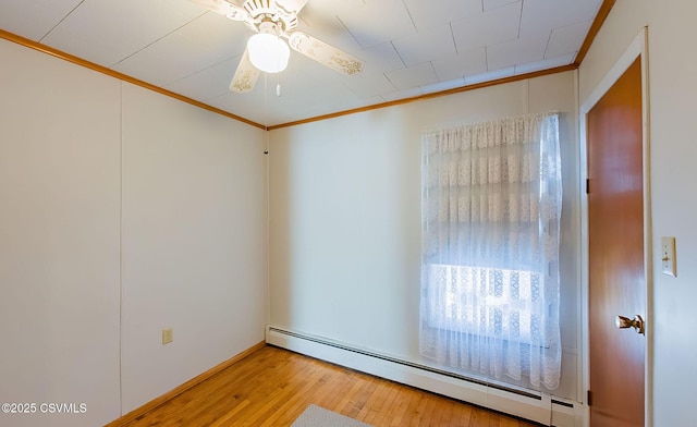 unfurnished room featuring a baseboard radiator, ornamental molding, hardwood / wood-style floors, and ceiling fan